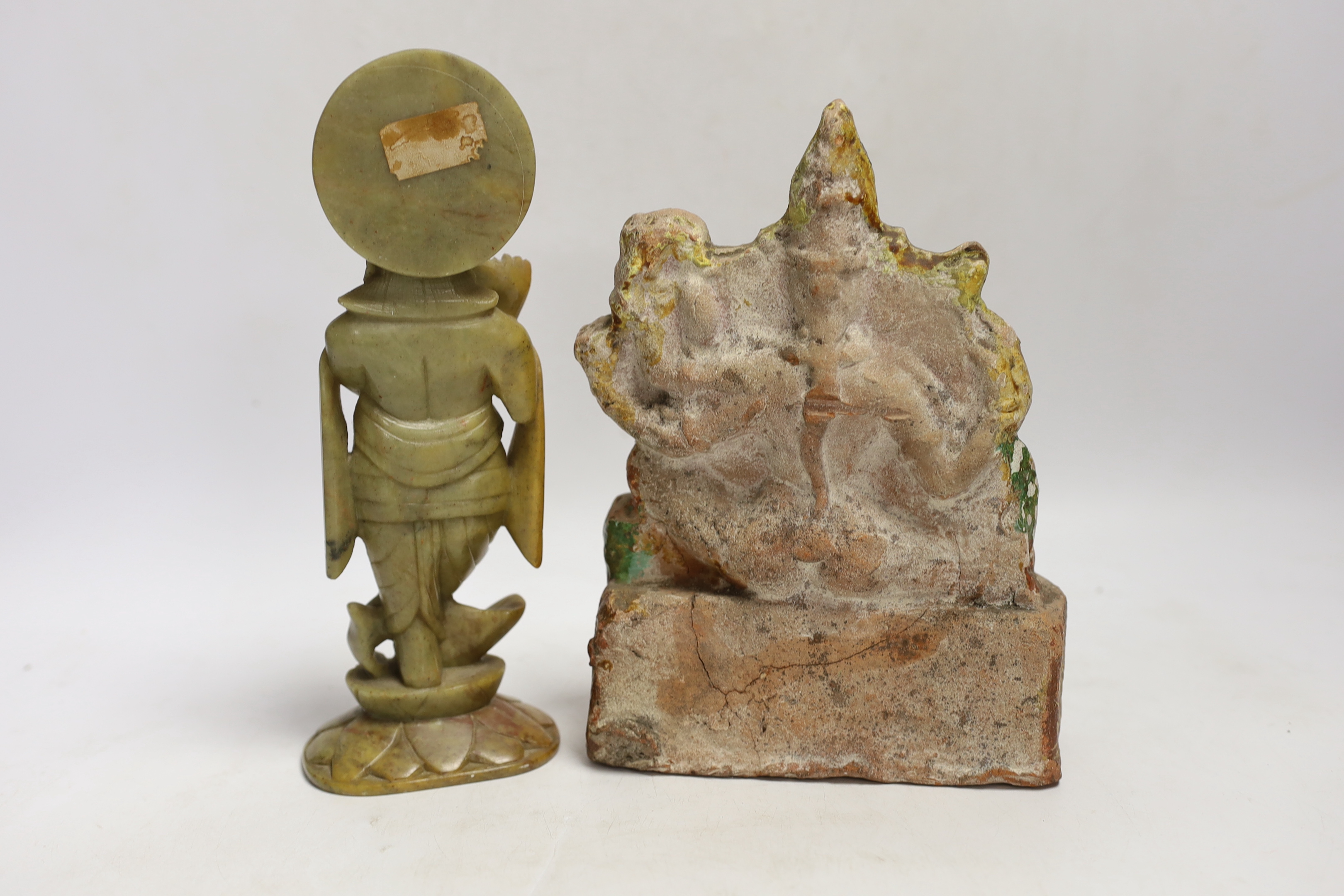 An Indian soapstone carved figure of Krishna and a terracotta figure of Saraswati, tallest 23cm